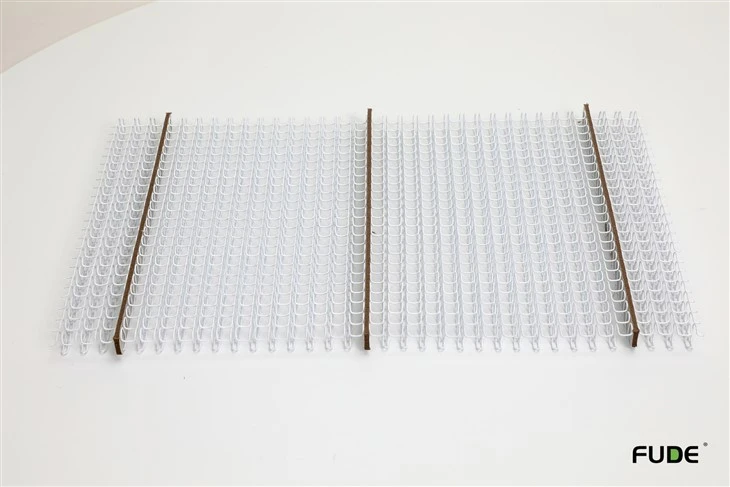 White pre-cut double loop wire elements arranged with separators